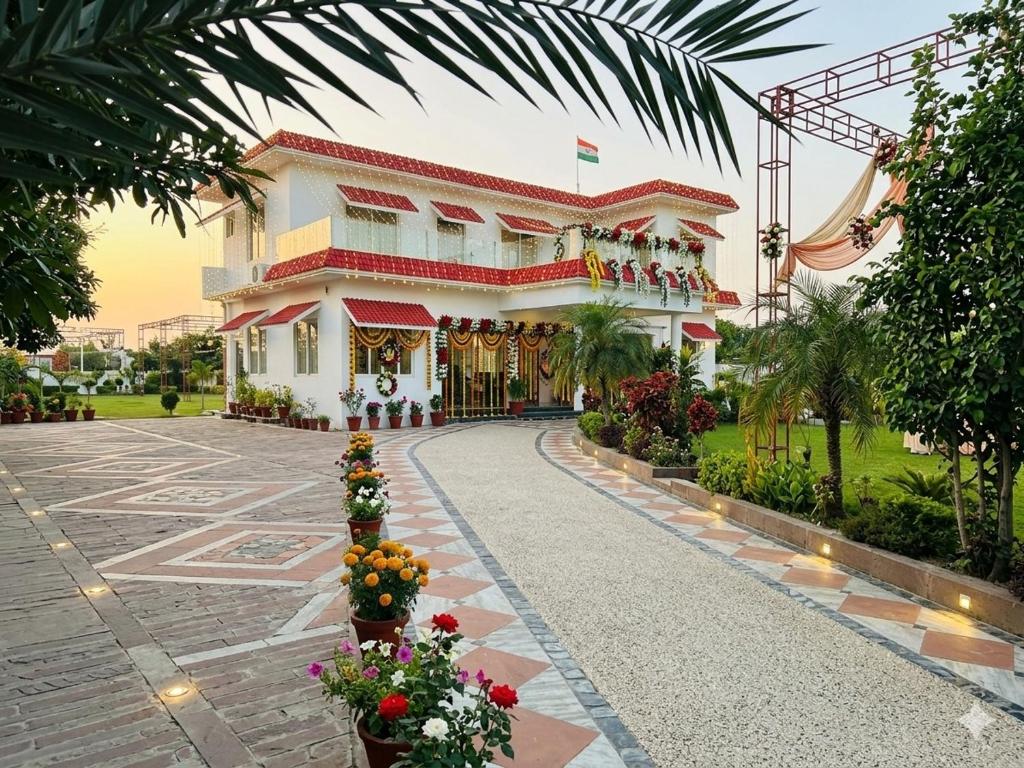 a building with flowers in front of it at royal palace and resort in Sultānpur