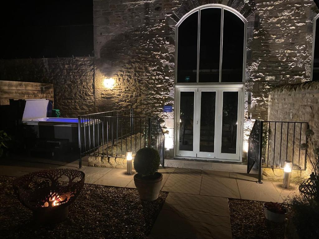 a patio with a door and lights in front of a building at The Granary - Uk40457 in Newsham
