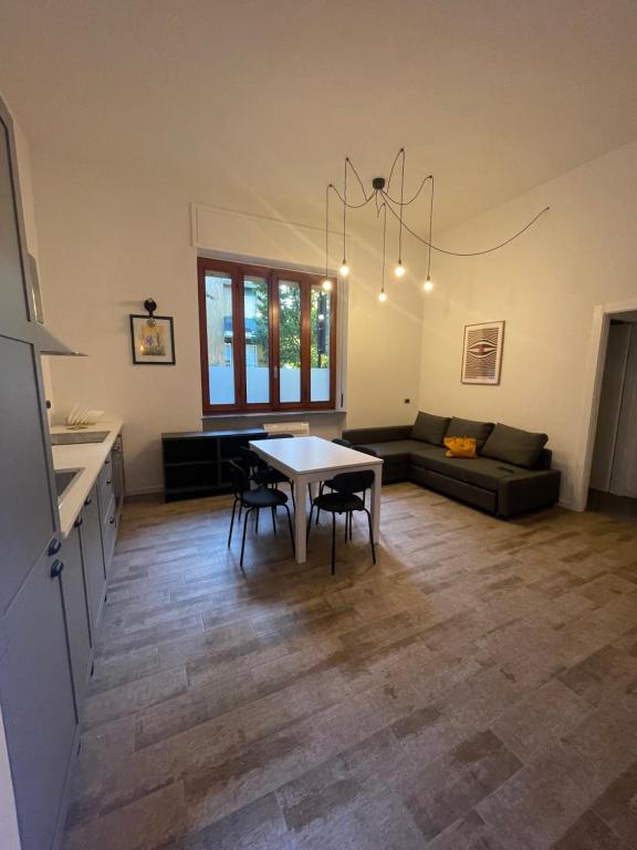 a kitchen and living room with a table and chairs at Teodolinda in Trezzo sullʼAdda