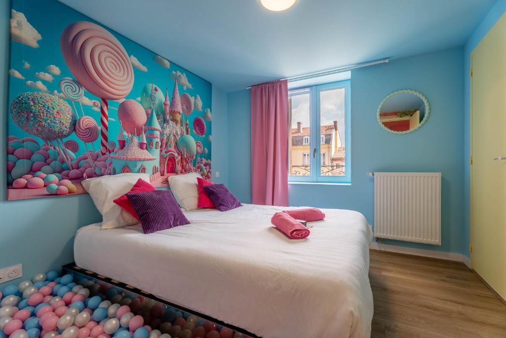 a bedroom with a large bed with a wall of balls at Le Candy by Clem in Pélussin