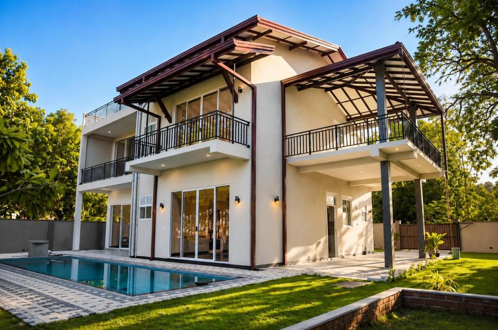 a house with a pool in front of it at Araliya Villa in Tangalle