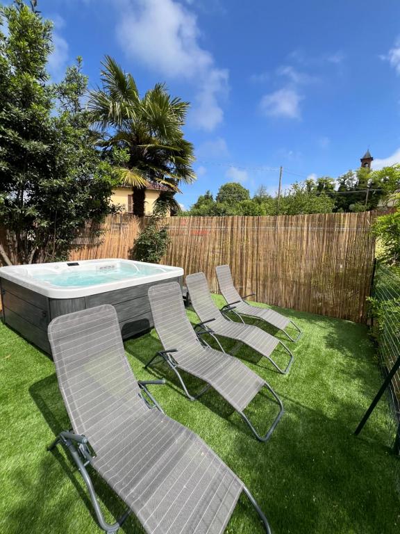 a group of chairs and a pool in a yard at Fermata Sessant in Asti