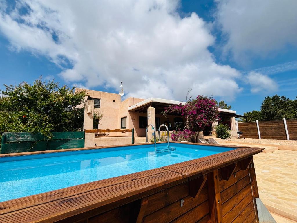 a swimming pool in front of a house at Villa Turquoise Formentera in San Ferrán de ses Roques