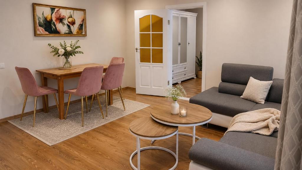 a living room with a table and a couch at Centro apartamentai in Zarasai