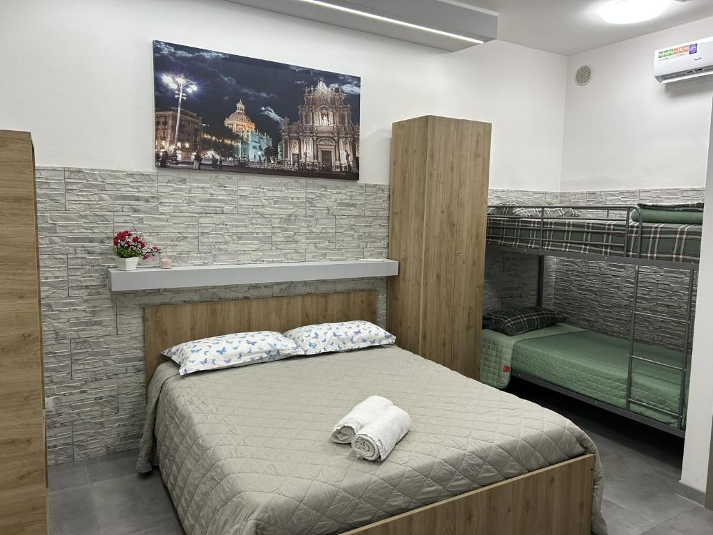 a bedroom with a bed with a picture on the wall at La Pescheria - Mini Apartments in Catania