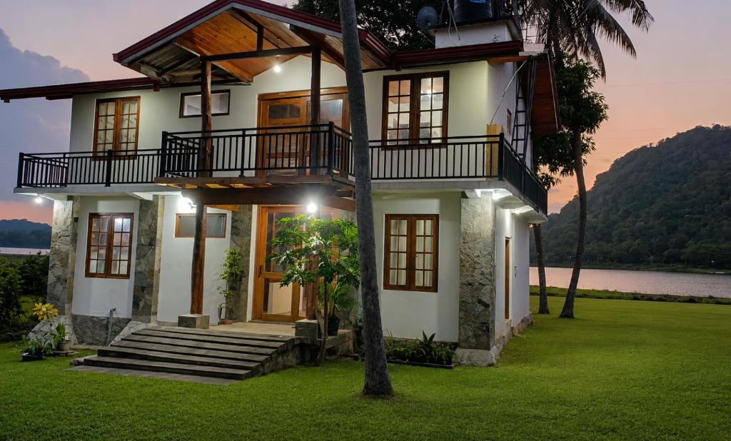 a house with a view of the water at Lakeside Echo Homestay in Kurunegala