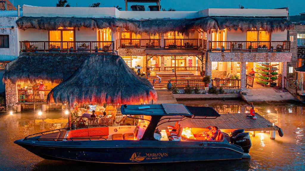 a boat in the water in front of a building at Casa Barú in Barú
