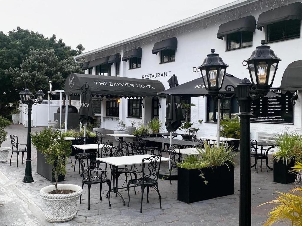 a restaurant with tables and chairs in front of a building at The Bay View Hotel in Richards Bay