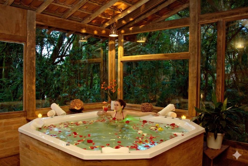 a child sitting in a bath tub in a room at Estalagem Wiesbaden in Monte Verde