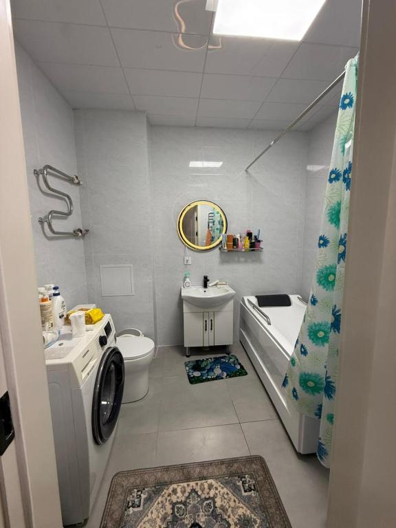 a bathroom with a sink and a toilet and a tub at 3 room SUPERIOR APARTMENT at ELITE TOWER in downtown NURBIE'S TRAVEL in Ölgiy