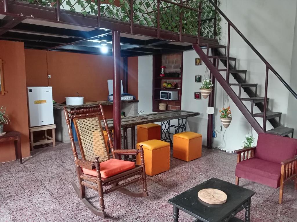 a living room with chairs and a staircase at "Casa de Piobeto" in Santa Ana