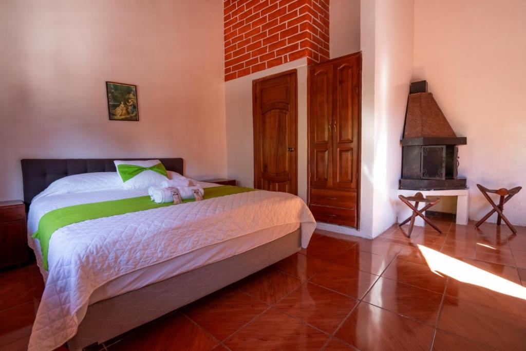 a bedroom with a bed with a teddy bear on it at Hostería Agoyán Deluxe in Ulba