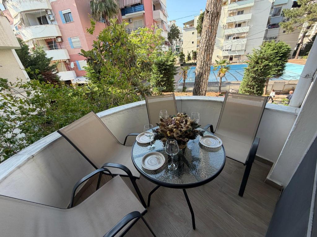 a table and chairs on a balcony with a view at Sunny hill Apartment in Golem
