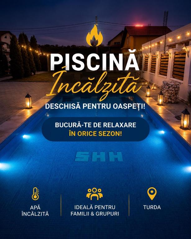 a poster of a resort with a swimming pool at night at Casa David Turda in Turda