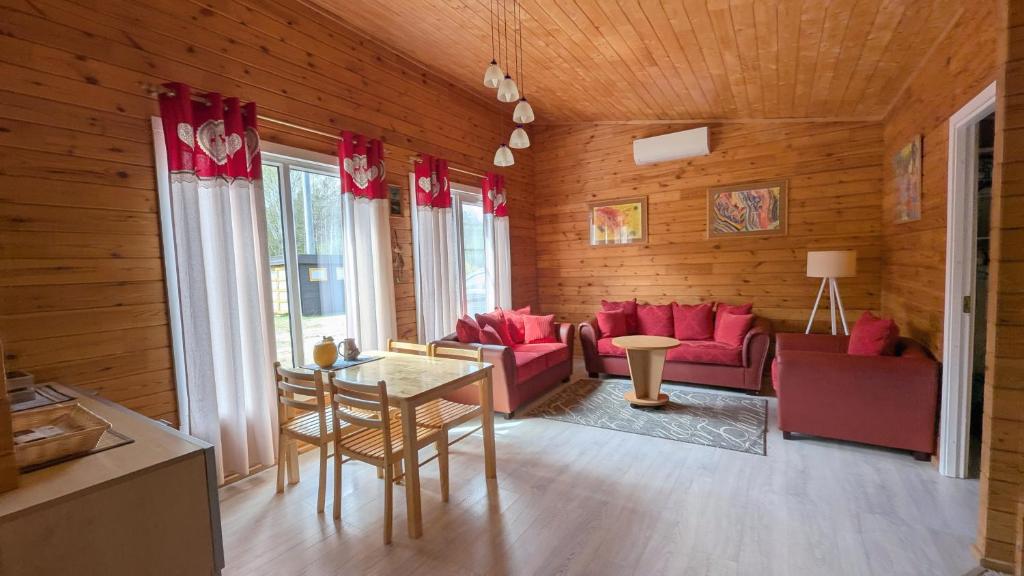 a living room with red furniture and wooden walls at Private Wood Cabin in Palanga