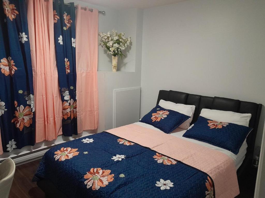 a bedroom with a bed with blue pillows at Dreamdoor Apartments in Moncton