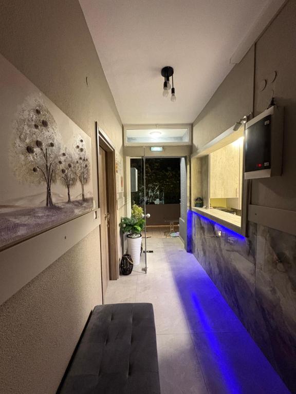a hallway with blue lights on a wall at Amelies Apartments in Paralia Katerinis