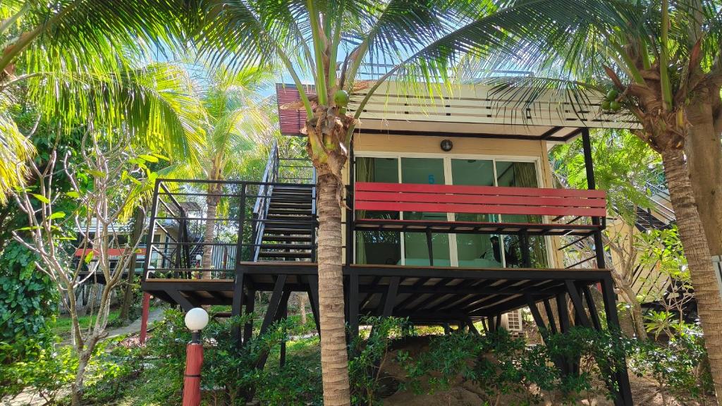 a house with a staircase up to a palm tree at Hill Zone Home Stay by Little Paradise in Haad Rin