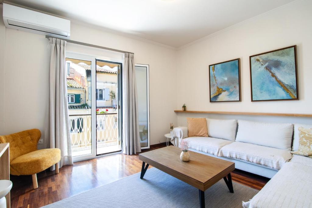 a living room with a couch and a table at Pinia Penthouse by Corfuescapes in Corfu