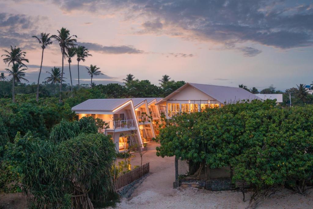 a house on the beach with lights on at Asaya Sands Mirissa in Mirissa