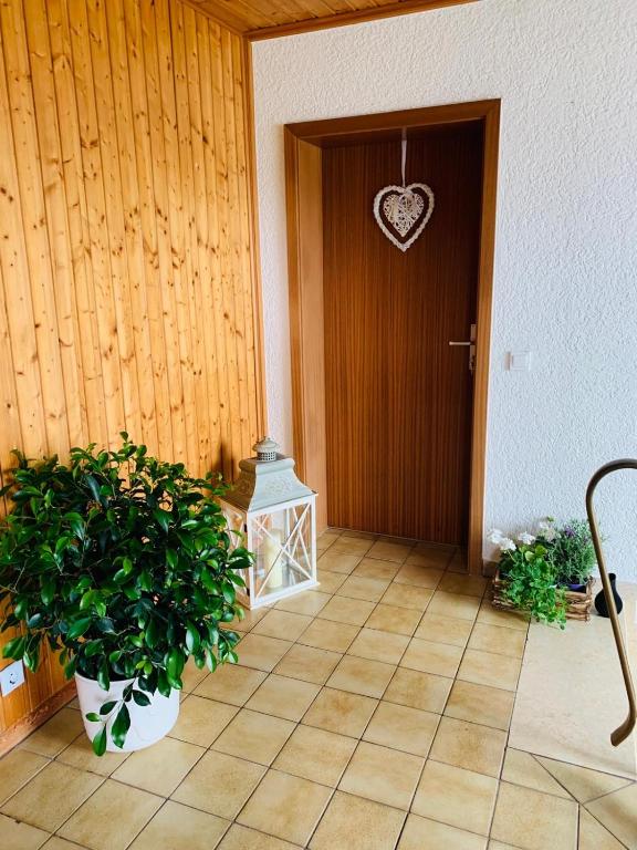 a wooden door with a heart hanging on it at Ferienidylle im Westerwald in Seck
