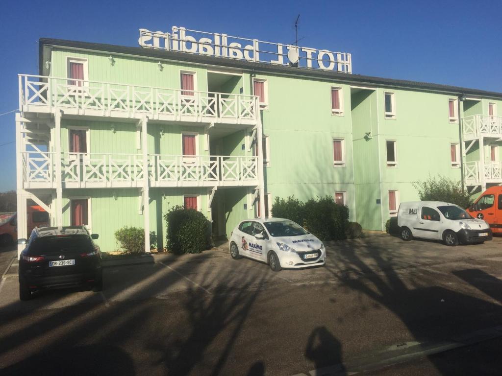 a white car parked in front of a building at initial by balladins Roissy / Saint-Mard in Saint-Mard