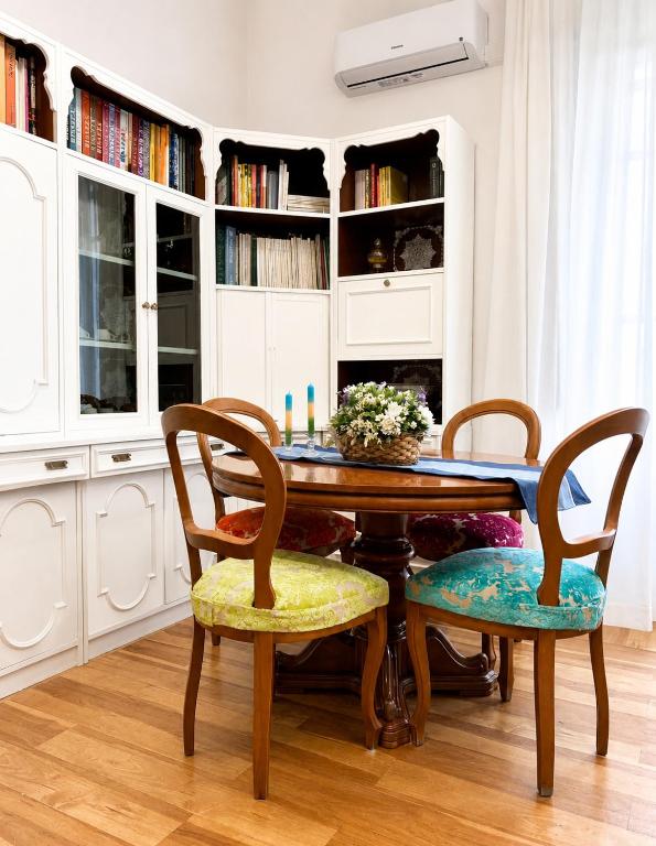 a dining room with a wooden table and chairs at Guest House A Due Passi in Olbia