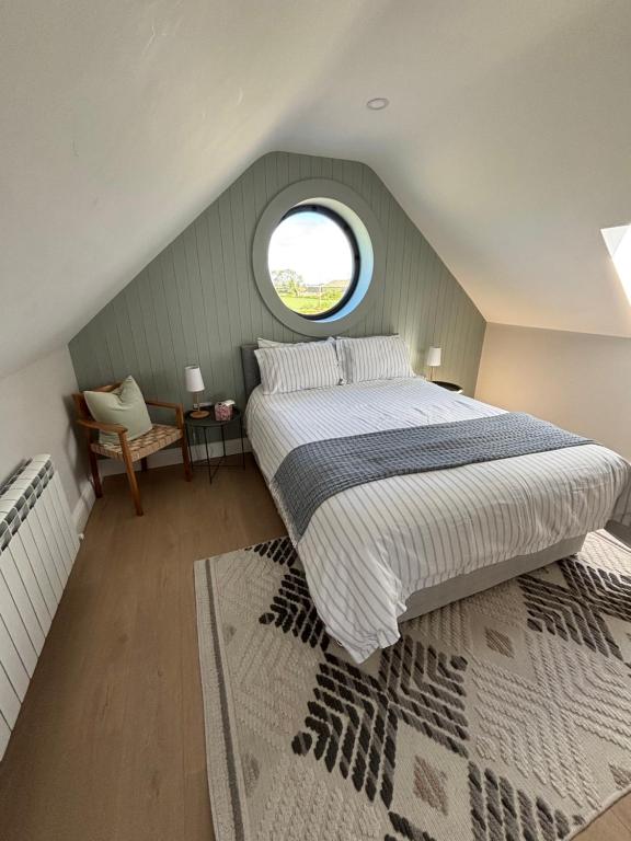 a bedroom with a large bed and a window at Beyren House Guest Suite in Emo