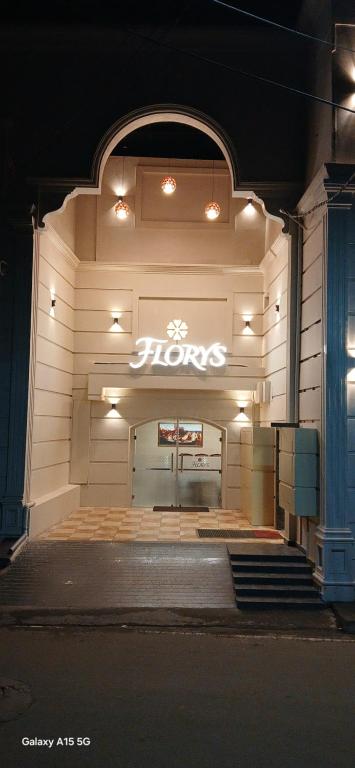 a store front with a hos sign on the wall at Florys Residency in Ooty