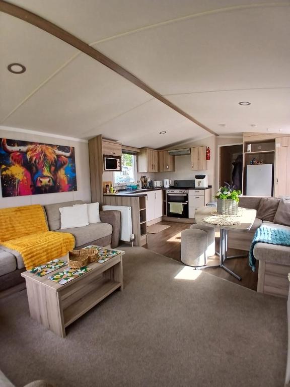 a living room with a couch and a table at 8 Moray View Seton Sands in Port Seton