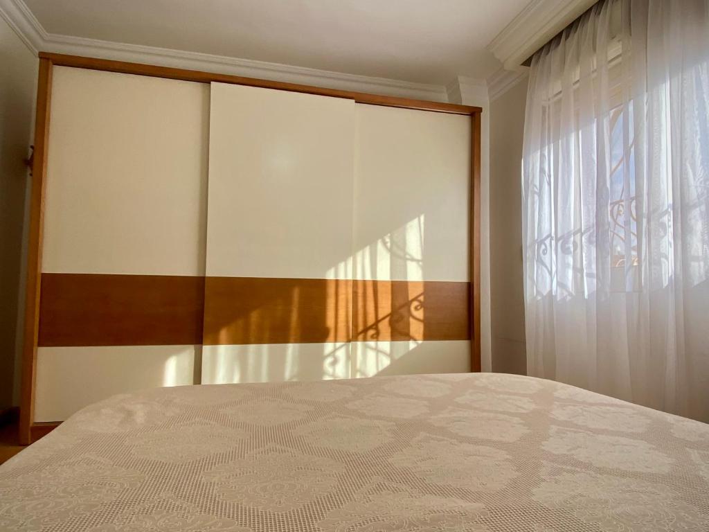 a bedroom with a large bed and a window at Golden Rose- men only in 6th Of October