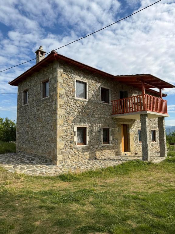 a stone house with a balcony on top of it at Hasan Nika's Tower in Karicë