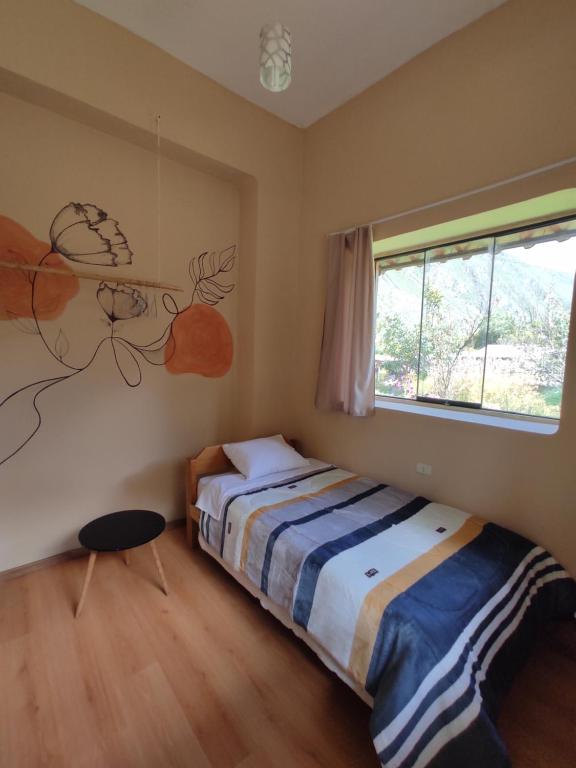 a bedroom with a bed and a window at Casa Unupaccha in Calca