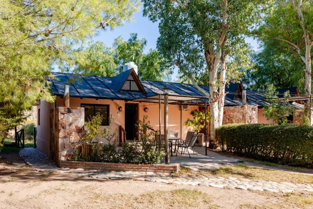 a house with a blue roof at Complejo Ermitazh in Valle Grande
