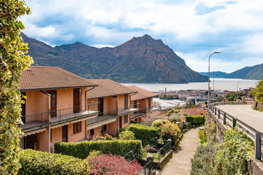 a row of houses with a mountain in the background at CASA di CRISTOF ISEO in Lovere