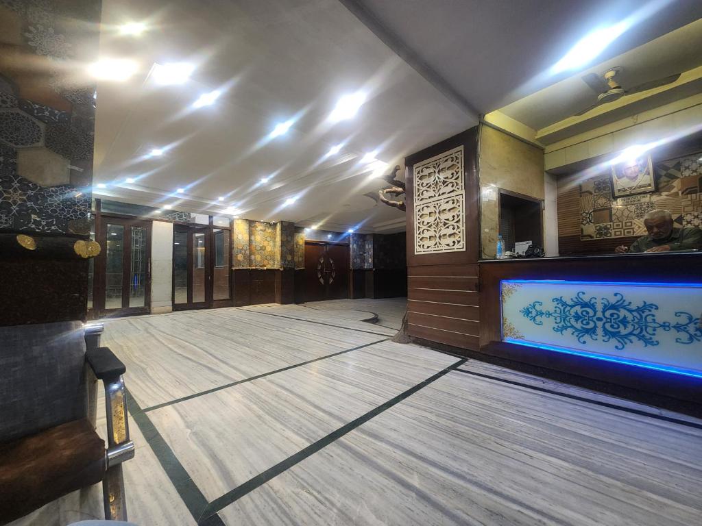 a hall with a bowling alley with a blue light at Hotel Shyam in Agra