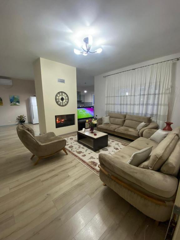 a living room with a couch and a fireplace at Luxury House in Shkodër