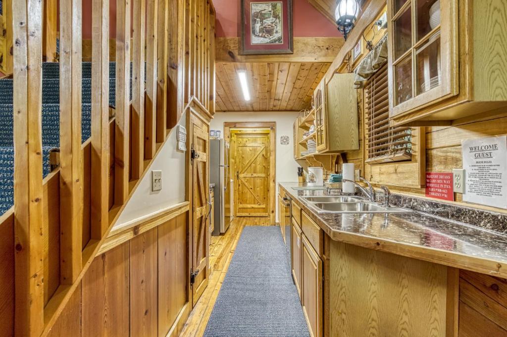 a kitchen with wooden cabinets and a wooden door at Barefoot Dreams in Sevierville