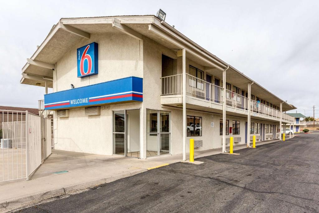 a hotel with a parking lot in front of it at Motel 6 Albuquerque Northeast in Albuquerque