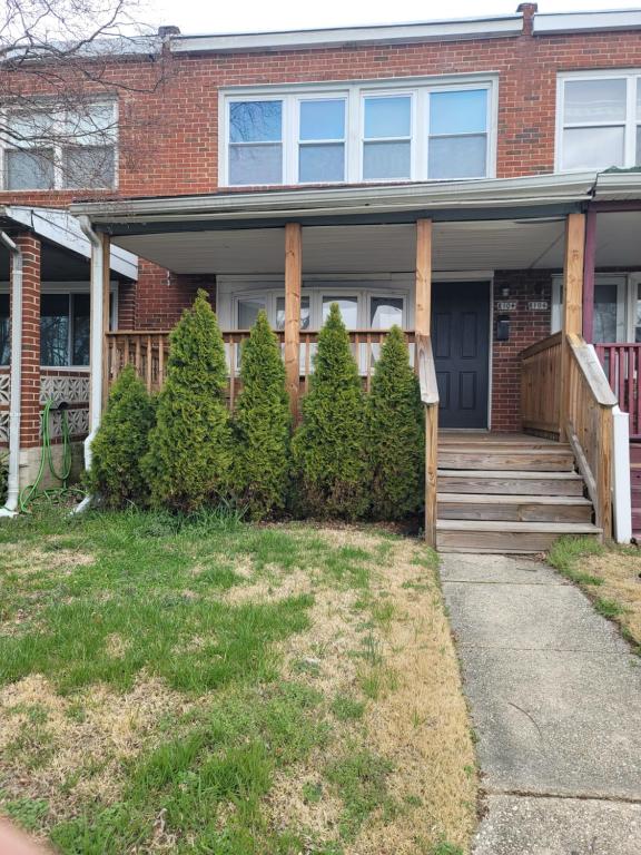 a brick house with a porch and some trees at The Haven in Dundalk