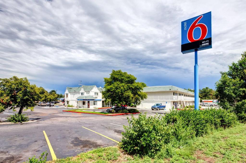 a sign in a parking lot in front of a building at Motel 6-Wheat Ridge, CO - West - Denver North in Wheat Ridge