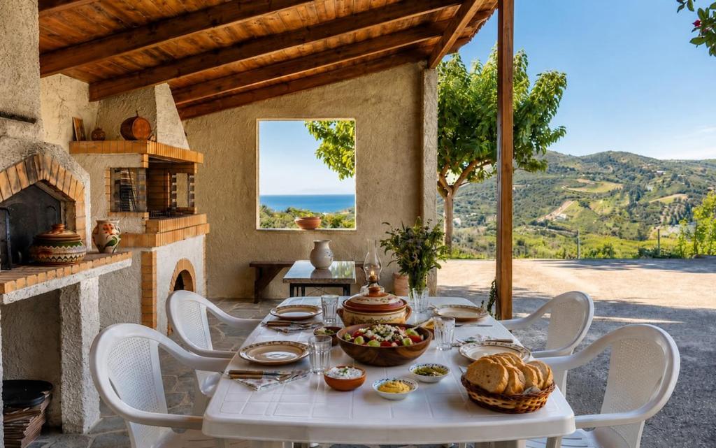 a white table with a bowl of food on it at Sea View Retreat in Oxílithos