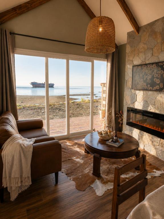 a living room with a view of the ocean at Boutique Cabin with Strait of Magellan Views in Punta Arenas