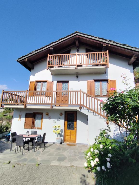 a large white house with a table and chairs at VILLA ADRY Aosta Sarre Your freedom in Aosta