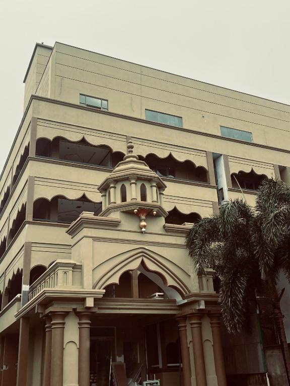 a large building with a tower on top of it at Hotel Sangiliyan in Jaffna