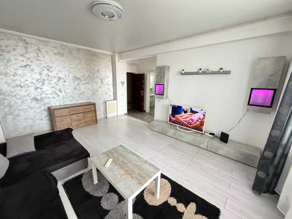 a living room with a couch and a table at R&C Relax Apartment 808 in Dudu