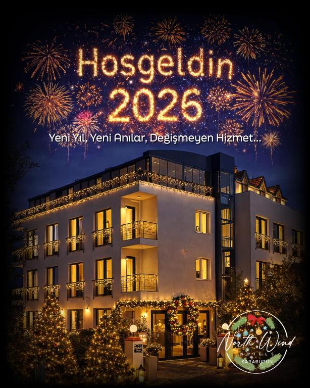 a sign for a hotel with christmas lights and fireworks at NORTH WIND HOTELS - Karaburun in Karaburun