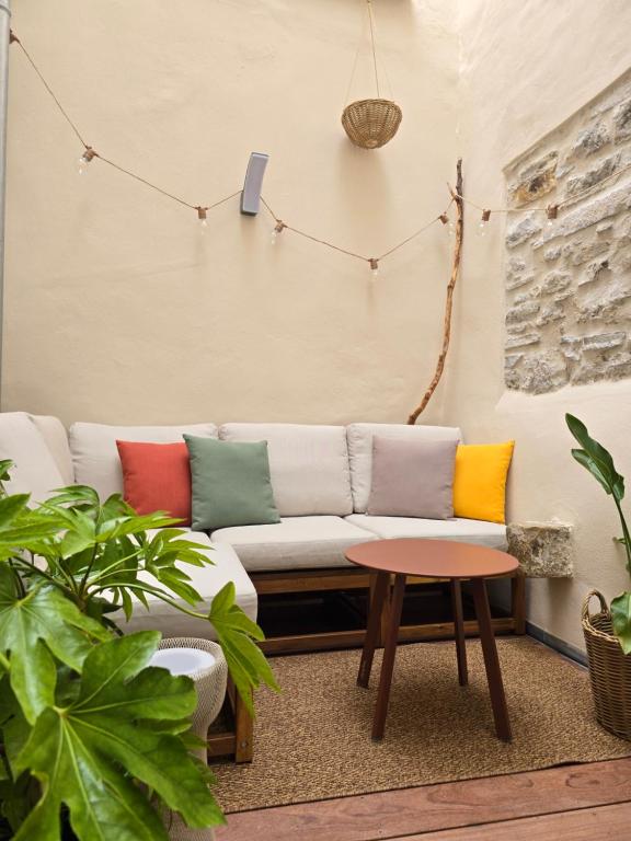 a living room with a couch with colorful pillows at Lanabi - Studio Cocon in Salies-de-Béarn