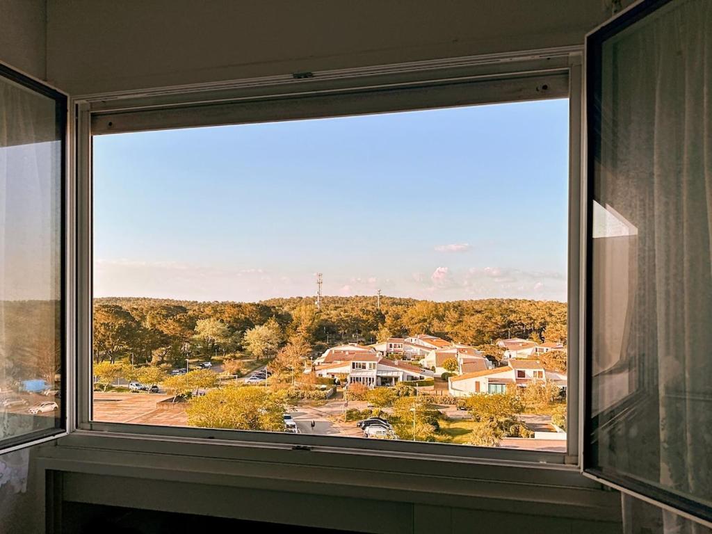 a large window with a view of a town at Studio entre mer et forêt in Saint-Jean-de-Monts