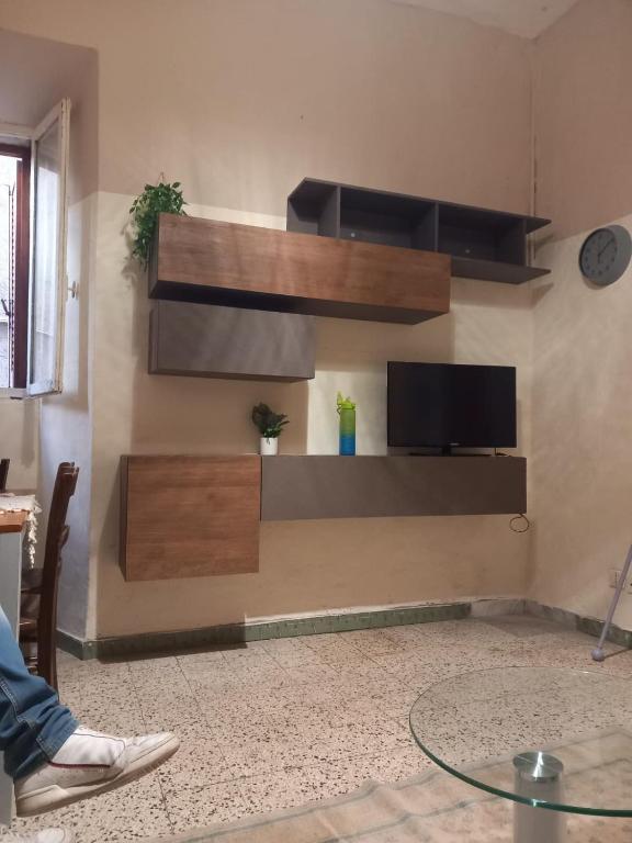 a living room with a tv on a wall at Serenity & Art in Viterbo